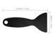 Black plastic screen scraper tool shown with dimension labels (135mm by 60mm) on a white background, plus three smaller inset photos demonstrating use on a phone screen and a phone.